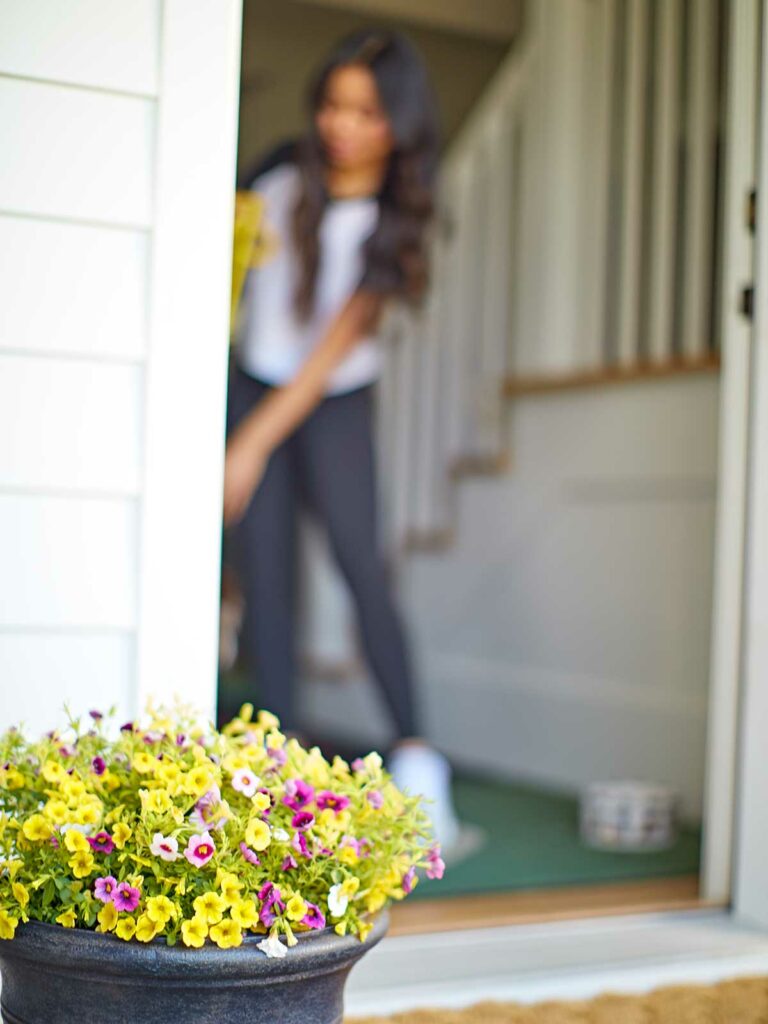 girl at door and a planter