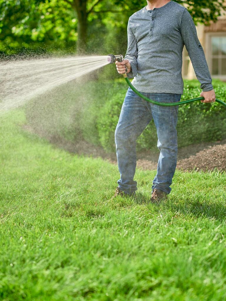 guy watering his lawn