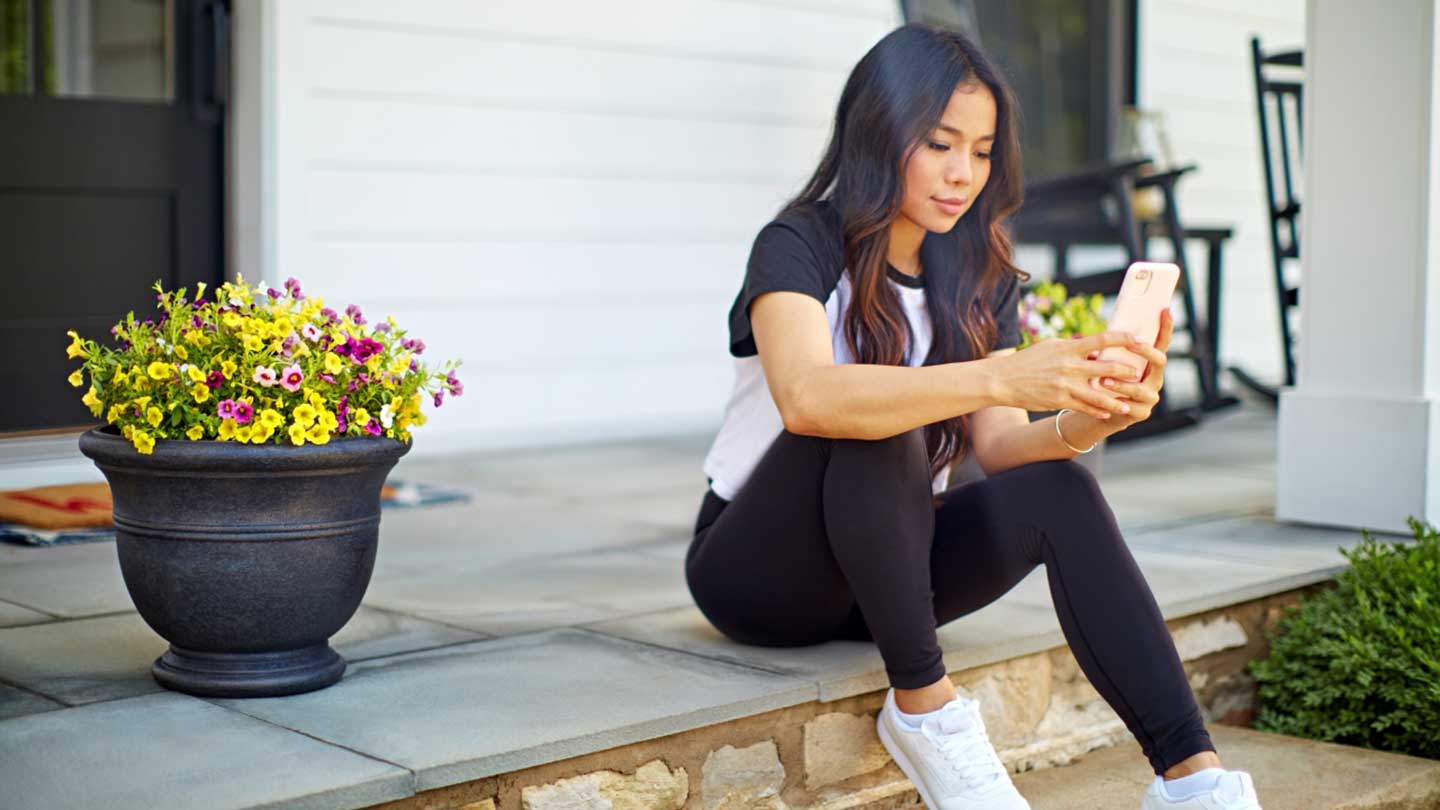 Lady Sitting on Decorated Porch